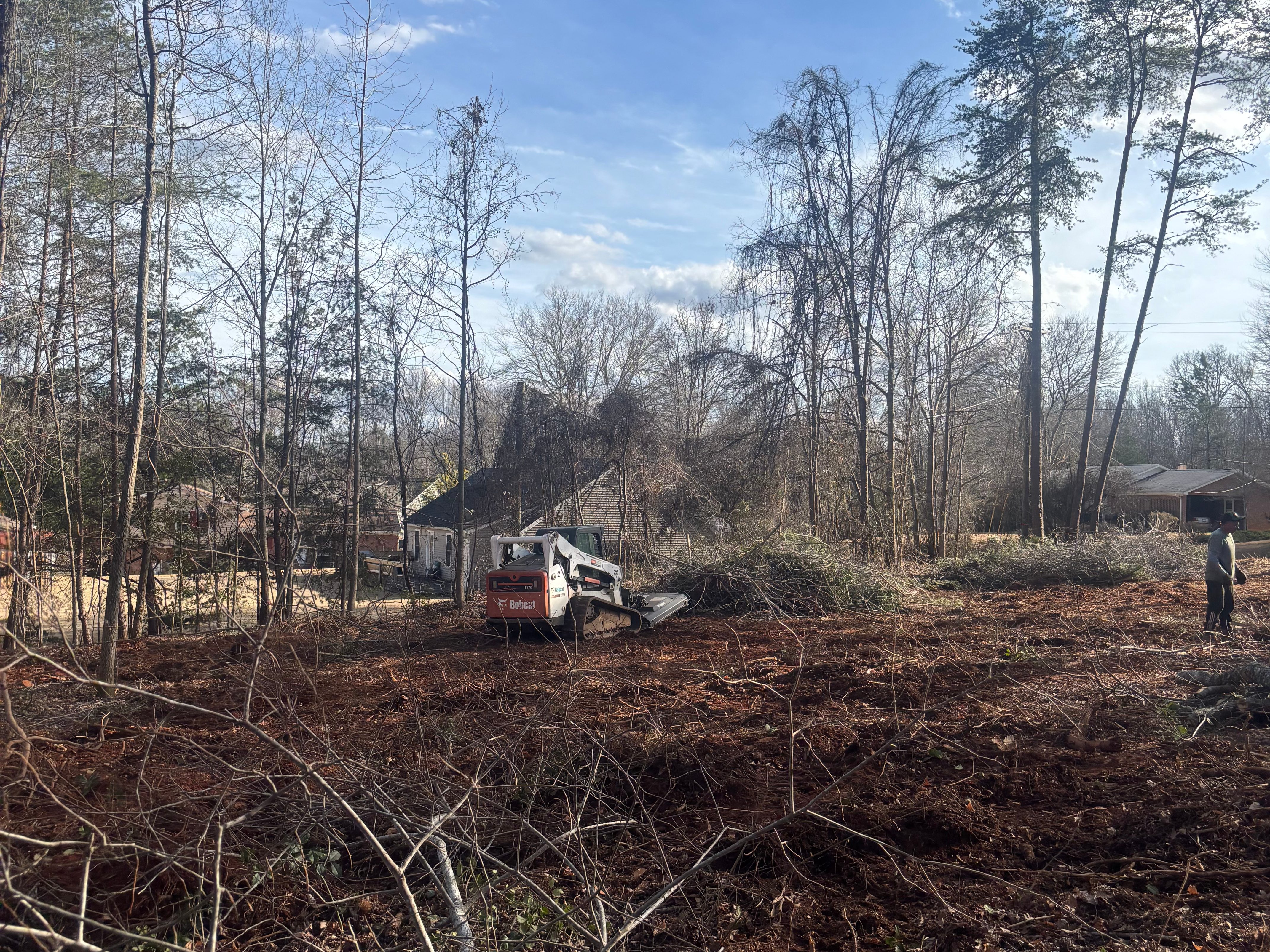 Land clearing with tree and brush removal completed by Villa’s Tree Services to prepare residential property.